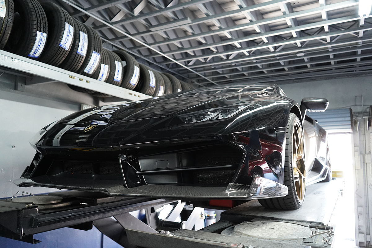 Technician using diagnostic scanning equipment on a vehicle